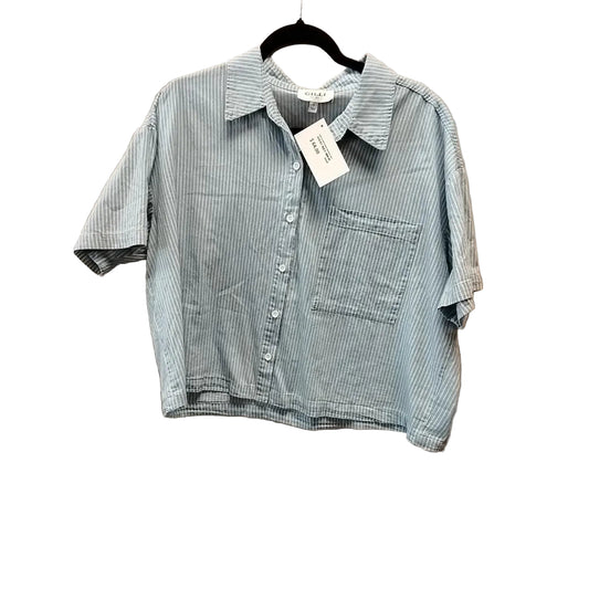 Blue and white striped shirt on a hanger against a beige background