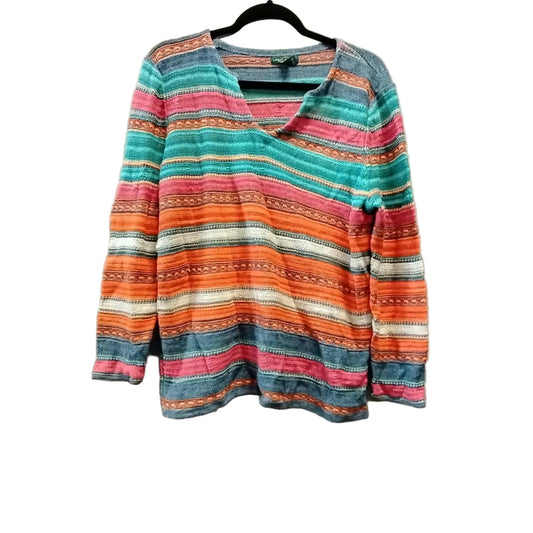 Colorful striped sweater on a hanger against a plain background